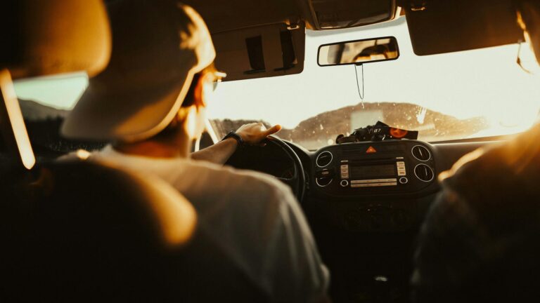 man holding the steering wheel while driving