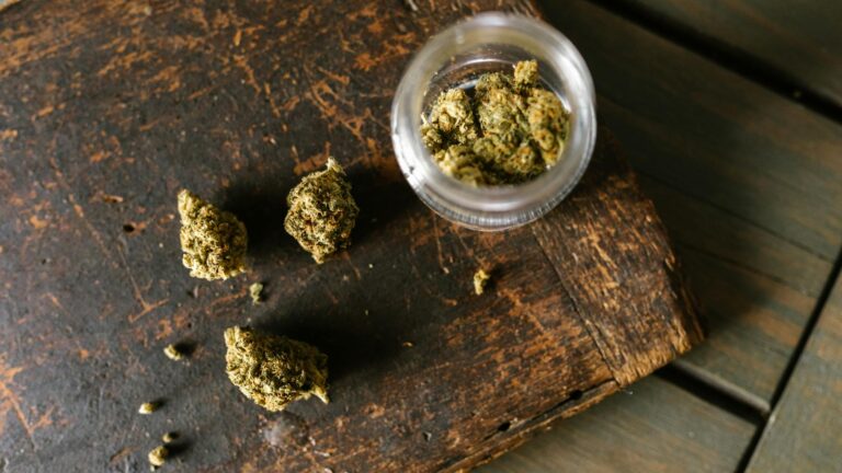 high angle shot of marijuana on wooden surface