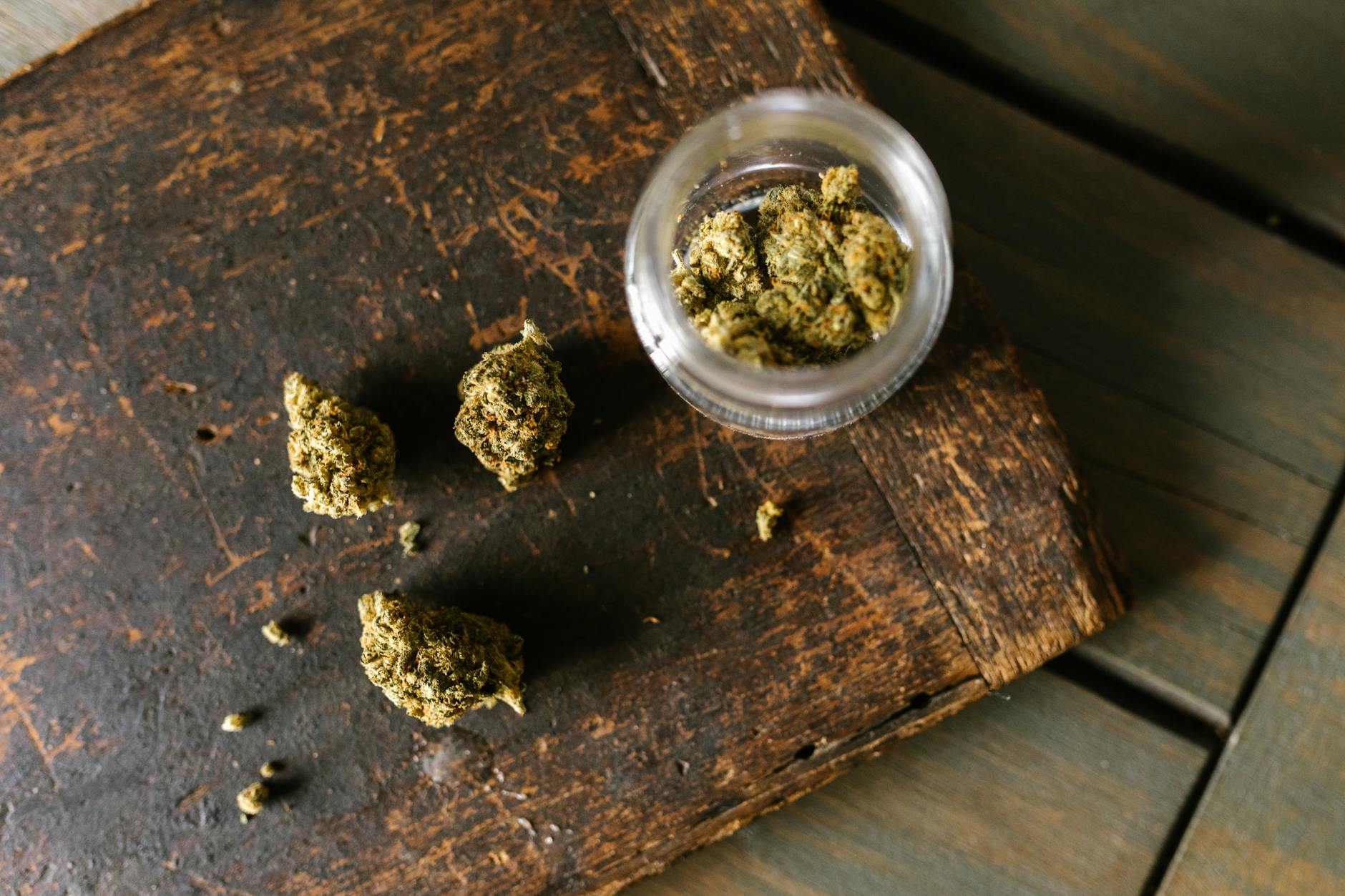 high angle shot of marijuana on wooden surface